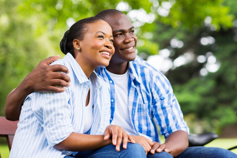 young african couple daydreaming